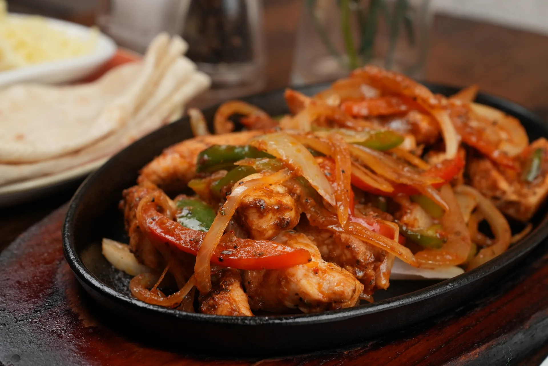 Sizzling chicken fajitas with smoked onions and peppers at Frida Camden — authentic Mexican restaurant in Camden London